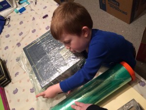 Declan helped wrap photo albums.