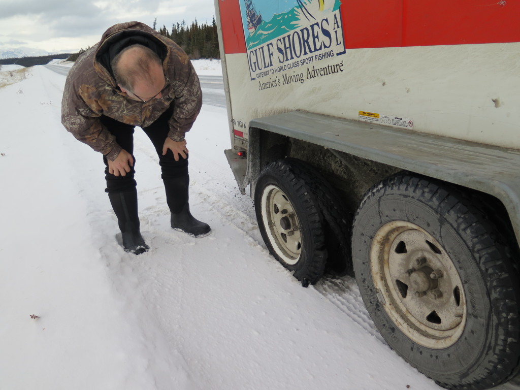 The bald head of the man I love! With the flat tire from our Uhaul trailer.