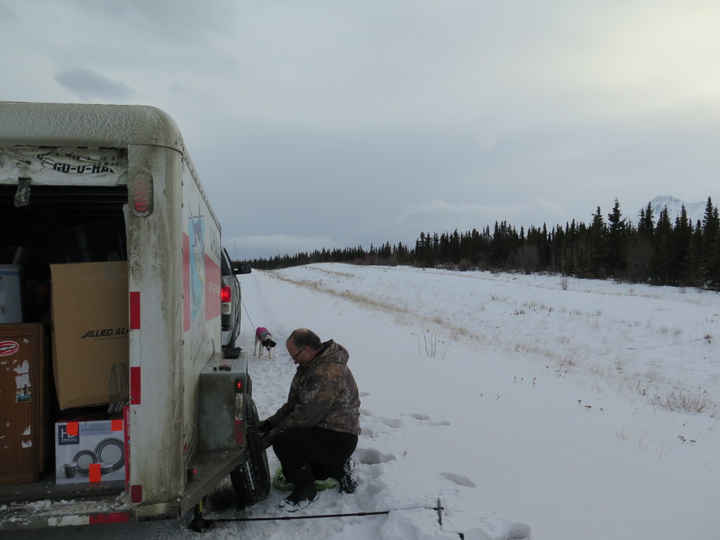 Changing flat tire on Uhaul trailer in Canada.